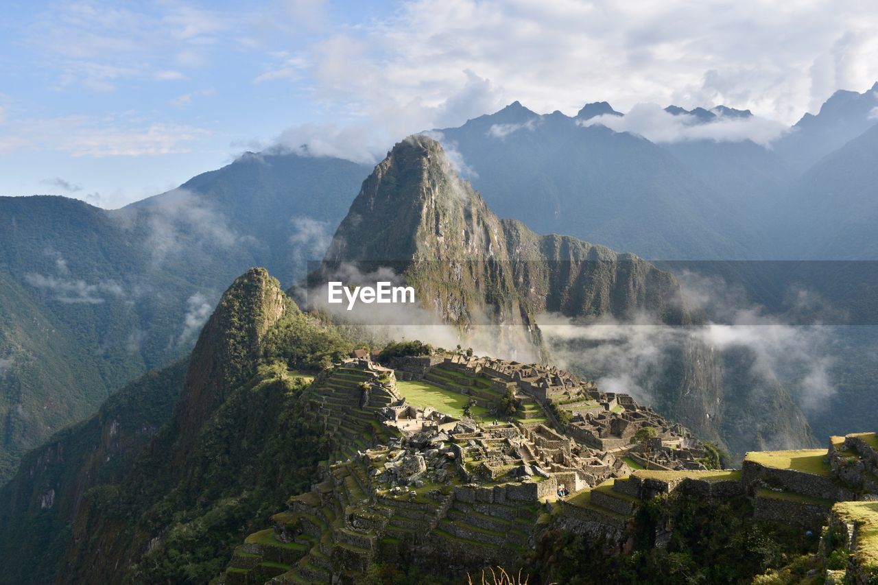 Panoramic view of mountains against cloudy sky