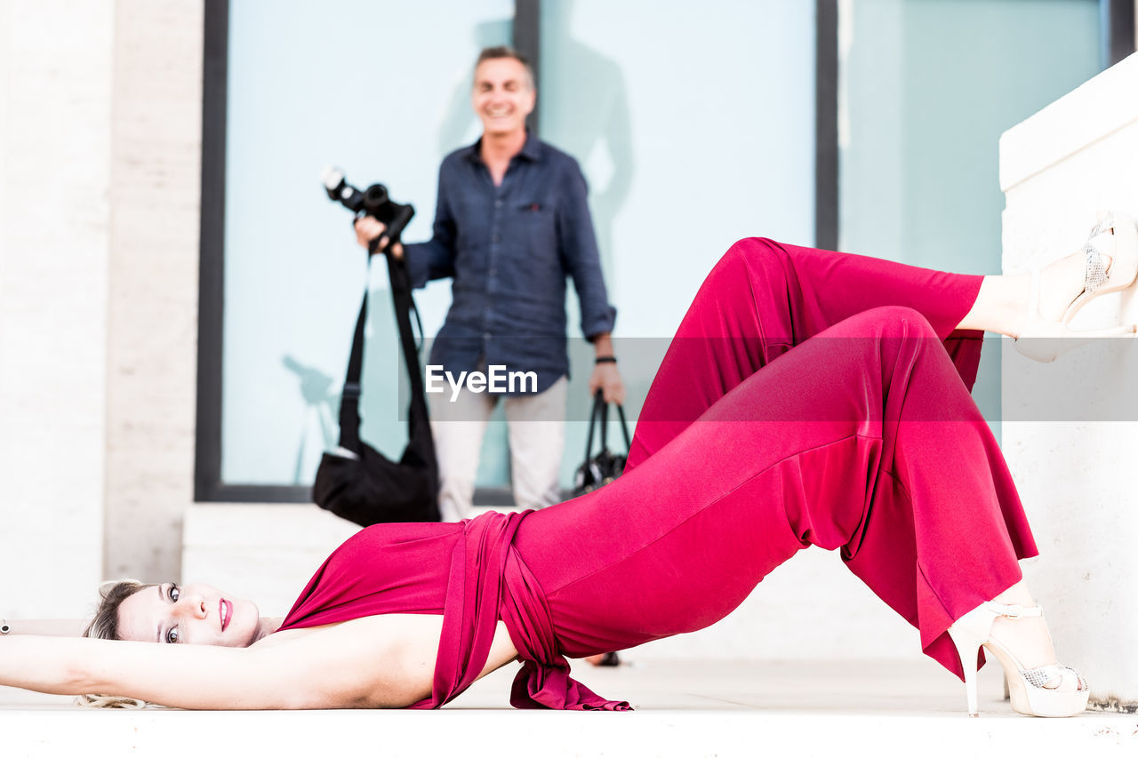 Full length of woman lying on flooring