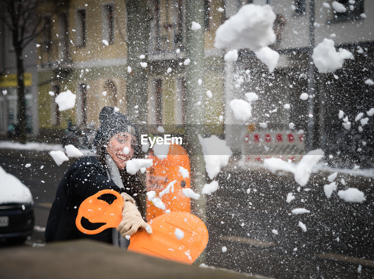 Woman throwing snow during winter