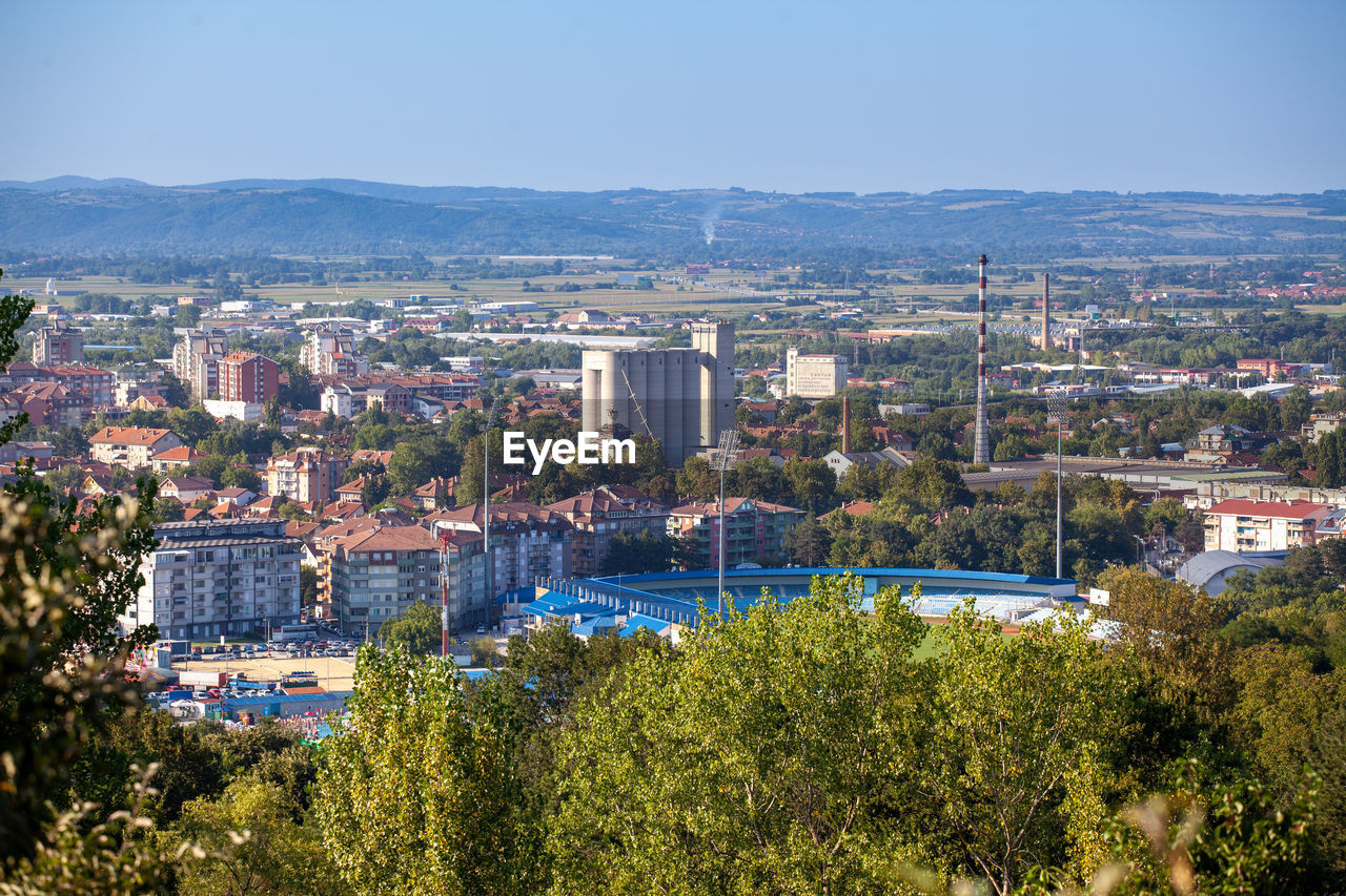 HIGH ANGLE VIEW OF BUILDINGS IN CITY AGAINST CLEAR SKY