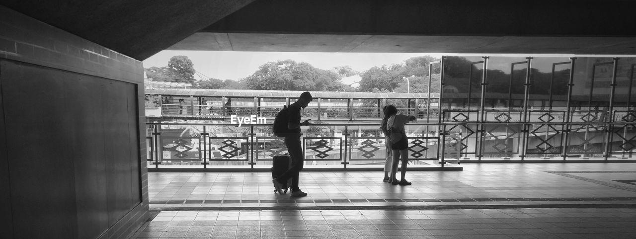 PEOPLE AT WINDOW IN CORRIDOR