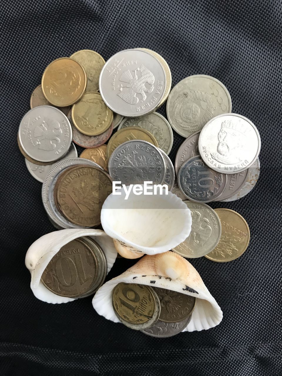 HIGH ANGLE VIEW OF COINS IN BOWL