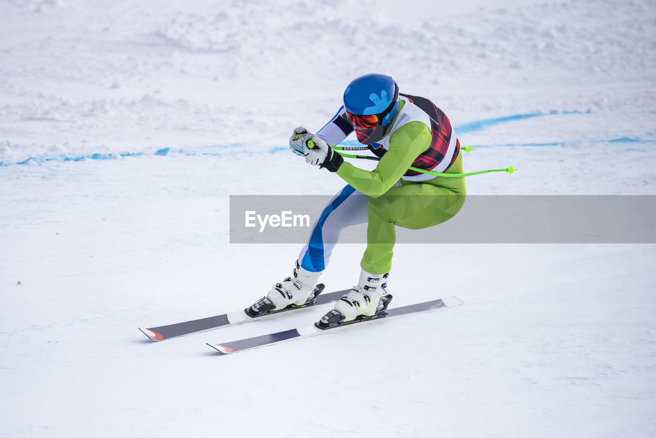 MAN SKIING ON SNOWY MOUNTAIN