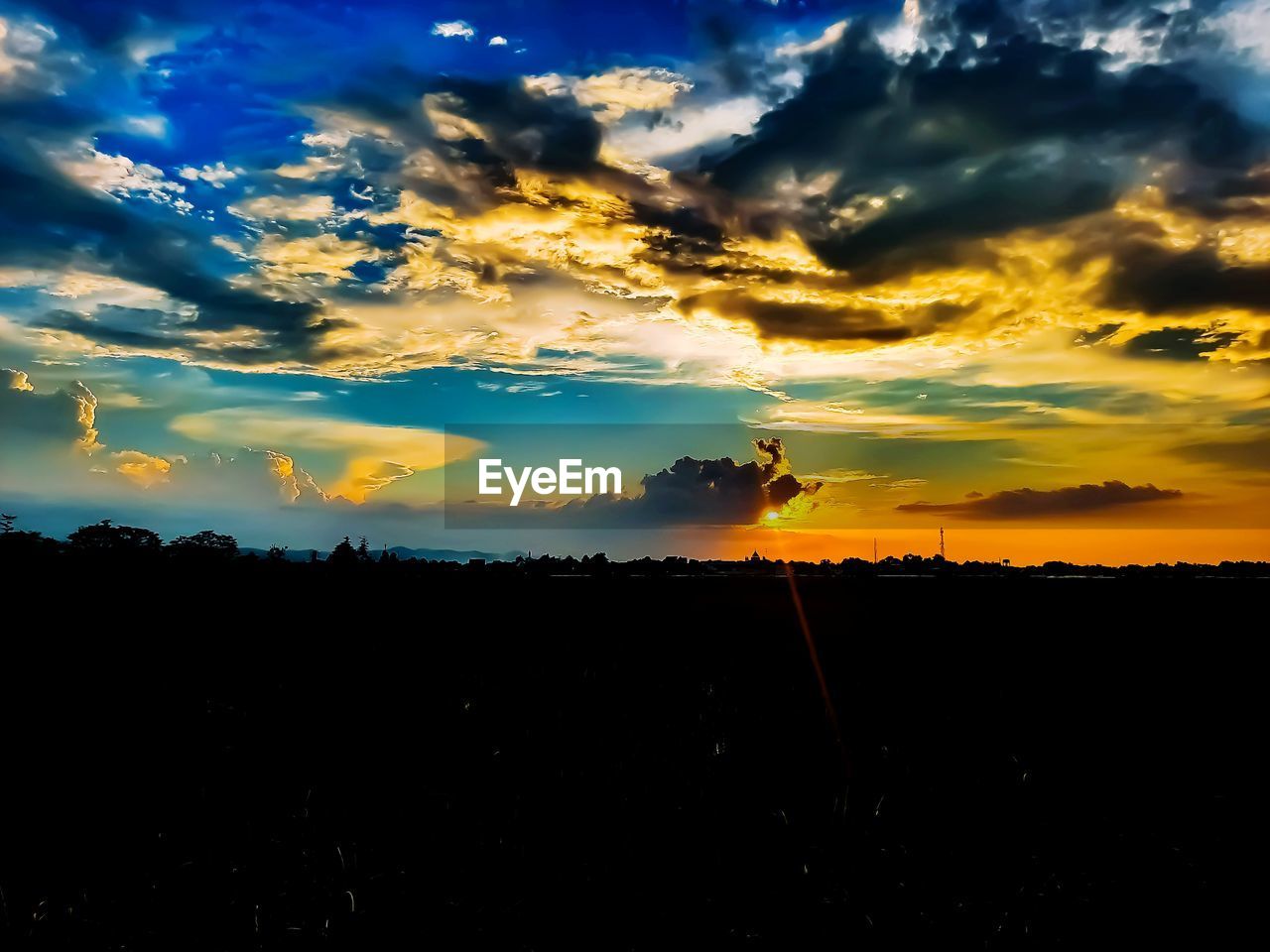 SCENIC VIEW OF SILHOUETTE LANDSCAPE AGAINST DRAMATIC SKY