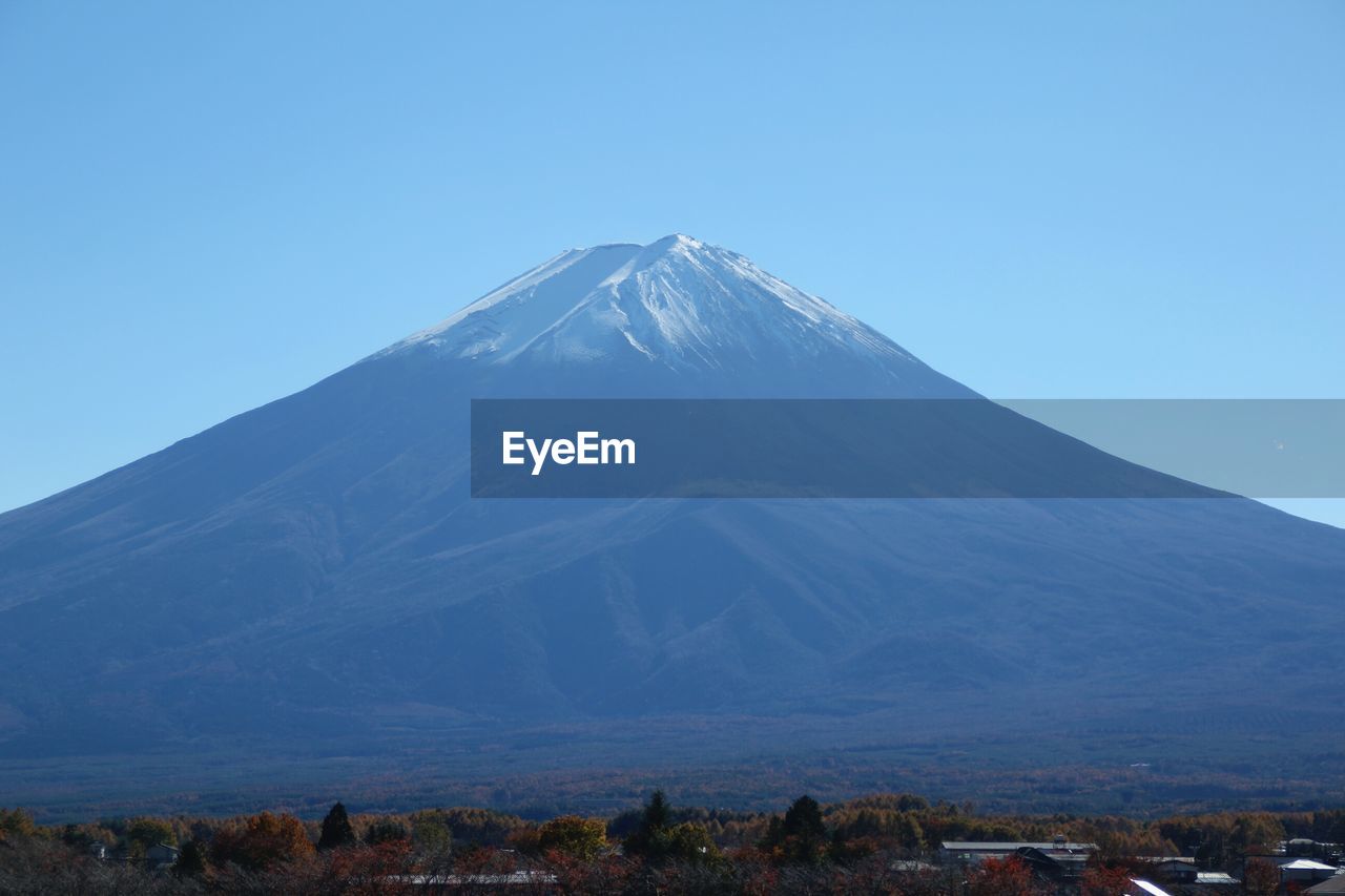 Scenic view of mountains against clear blue sky