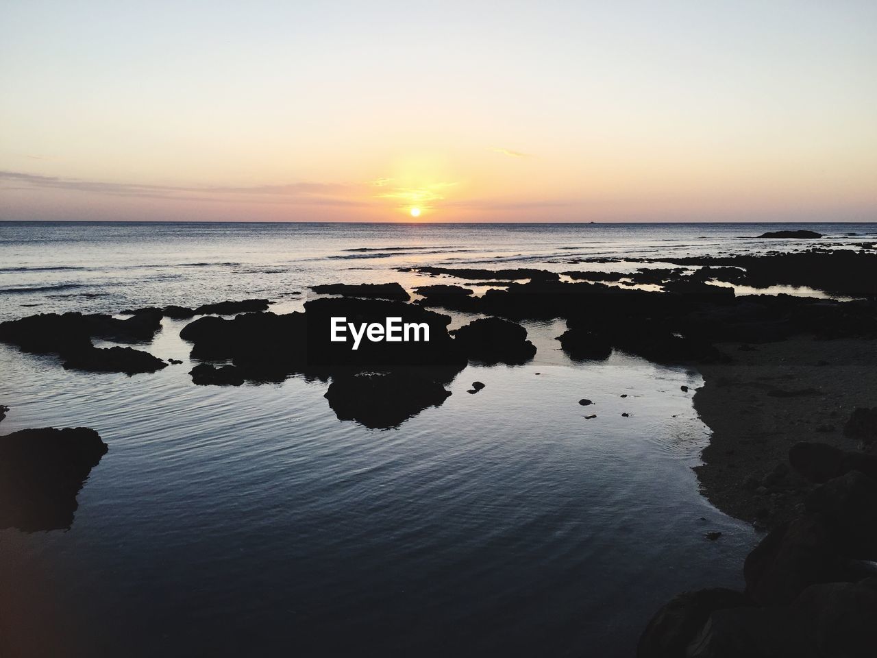 Scenic view if sea against sky at sunrise