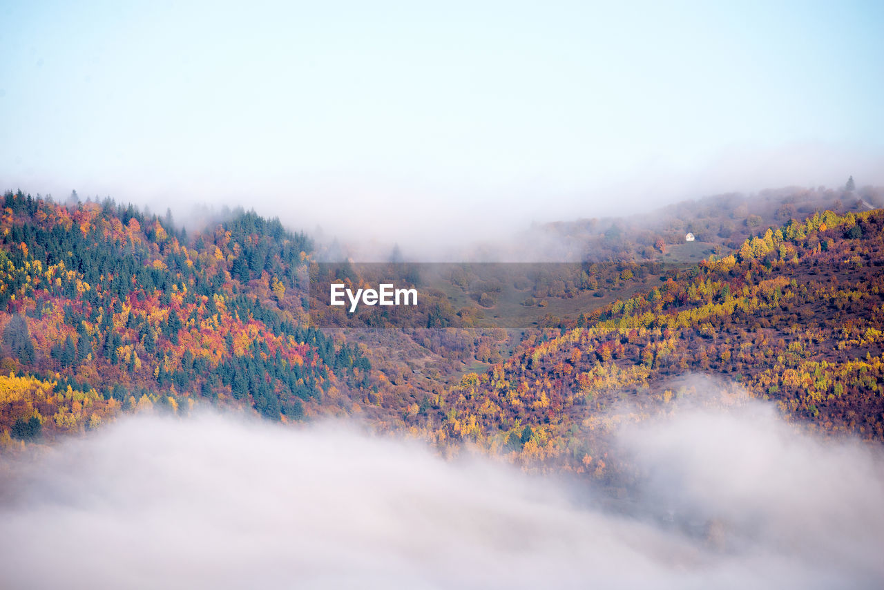 Scenic view of land against sky during autumn