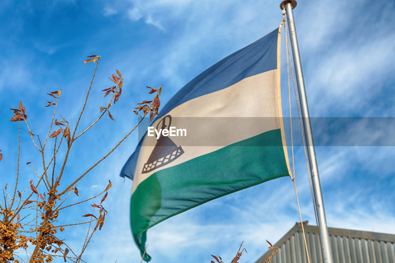 LOW ANGLE VIEW OF FLAGS AGAINST SKY