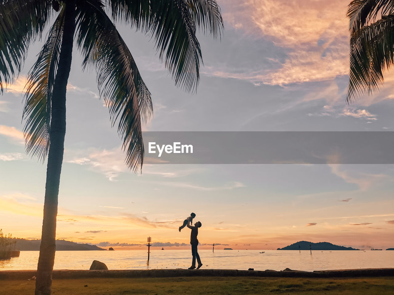 Man standing at beach during sunset