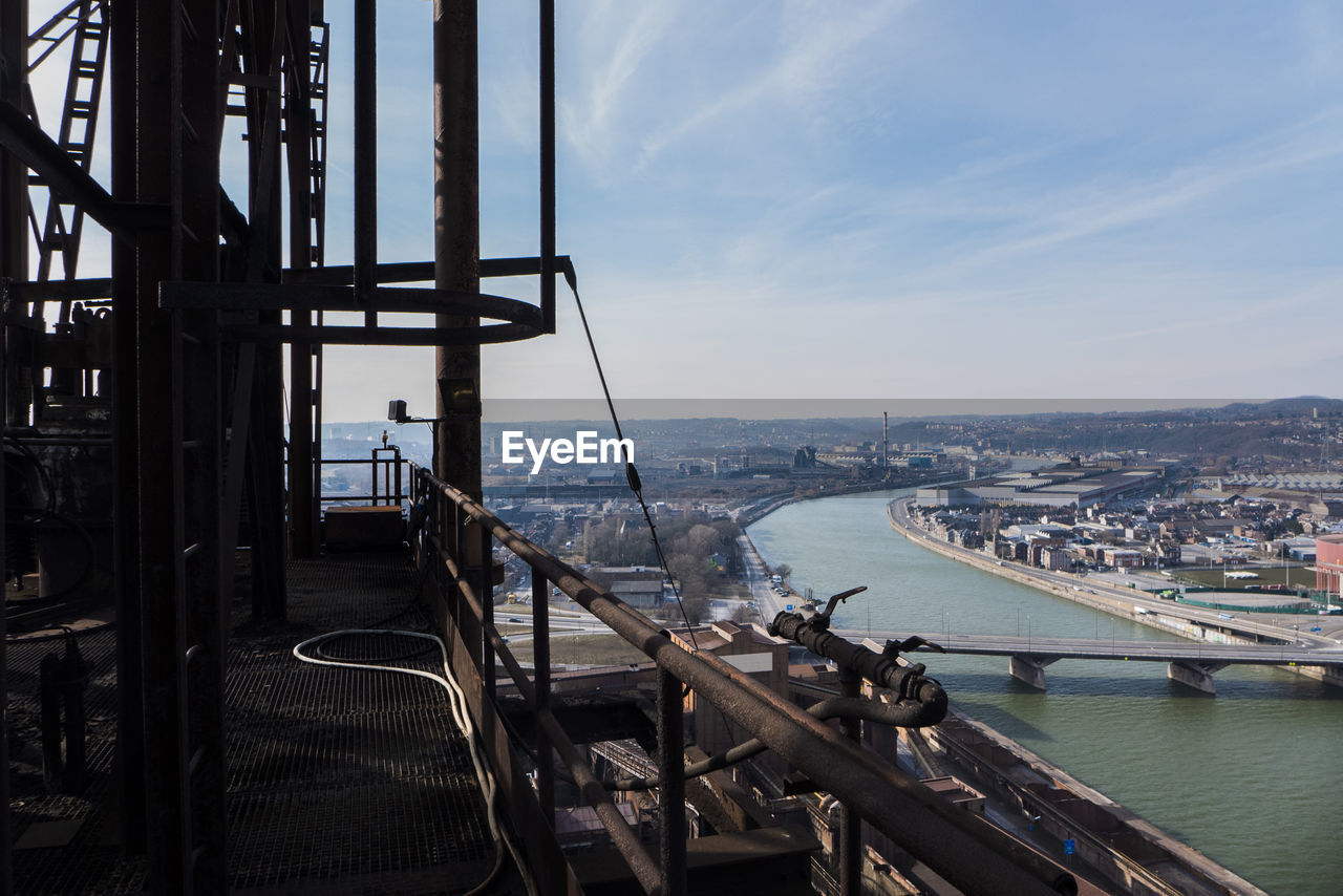 Scenic view of sea and cityscape against sky