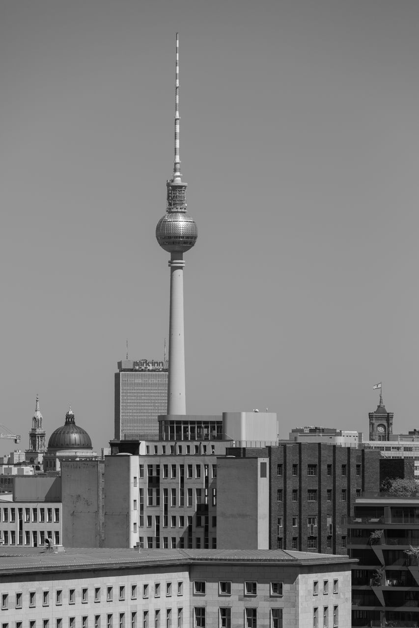 Buildings in city against clear sky