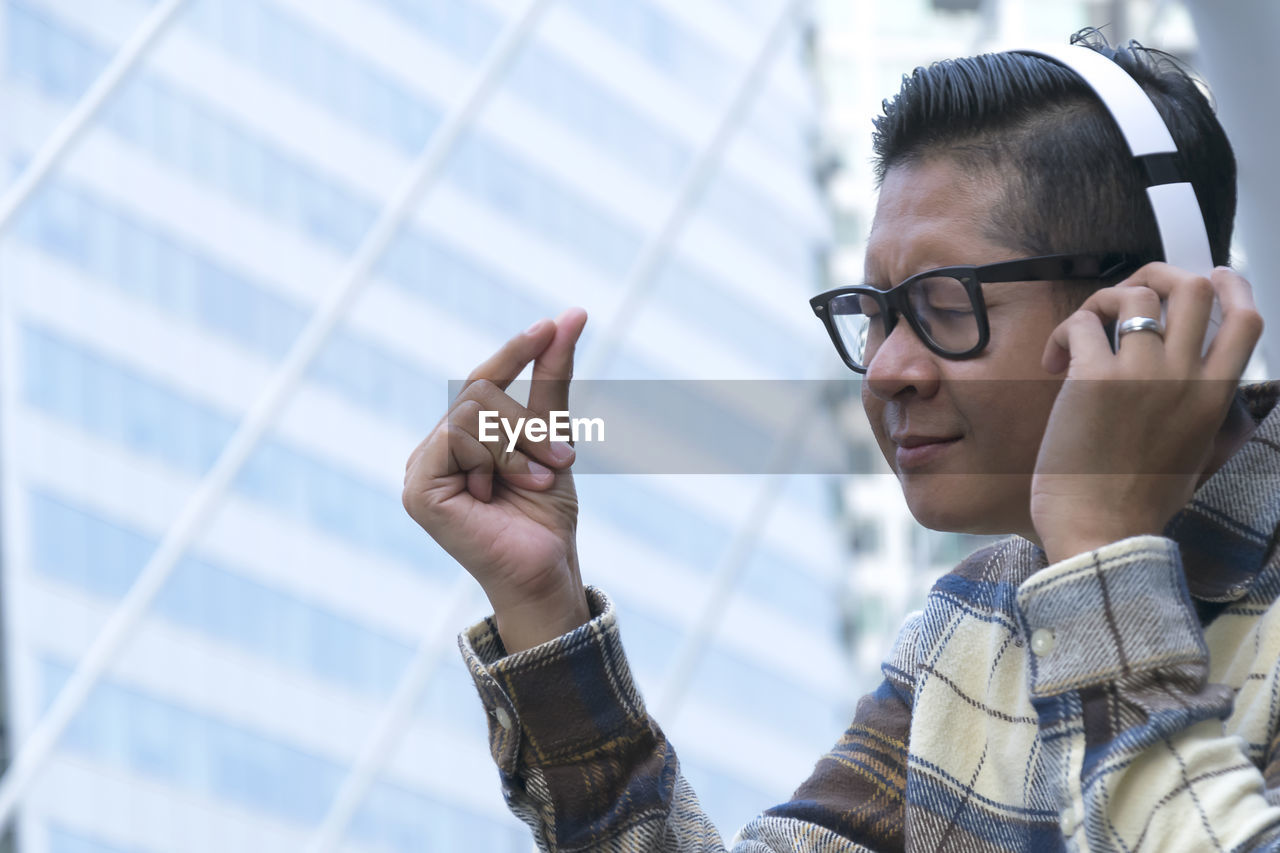 Man enjoying music through wireless headphones