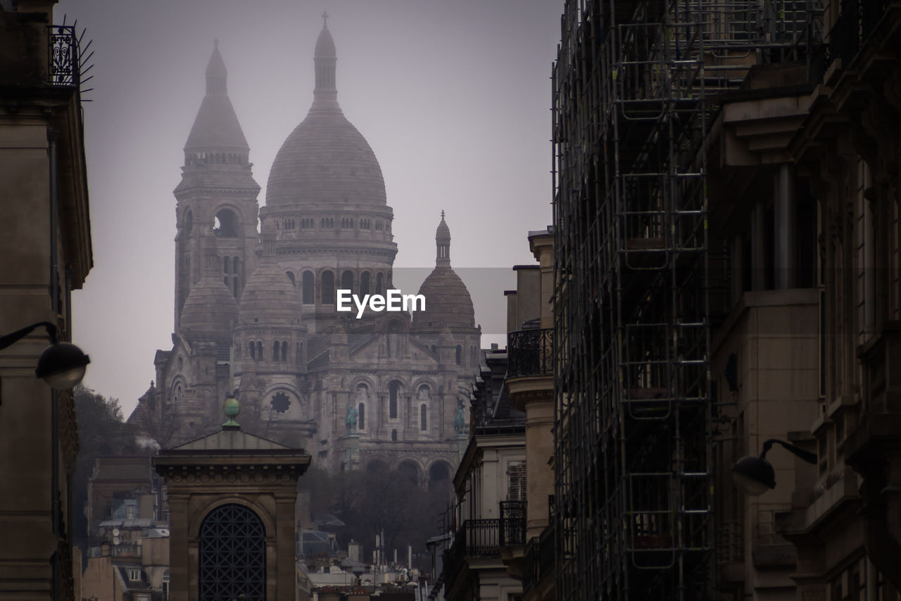 Misty sacre coeur from the streets of paris, france