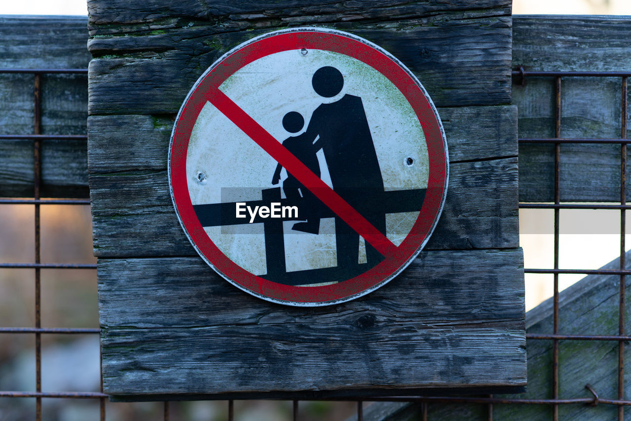 Close-up of information sign on wood