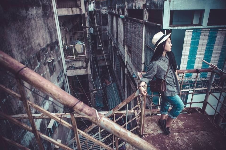 WOMAN STANDING ON RAILING