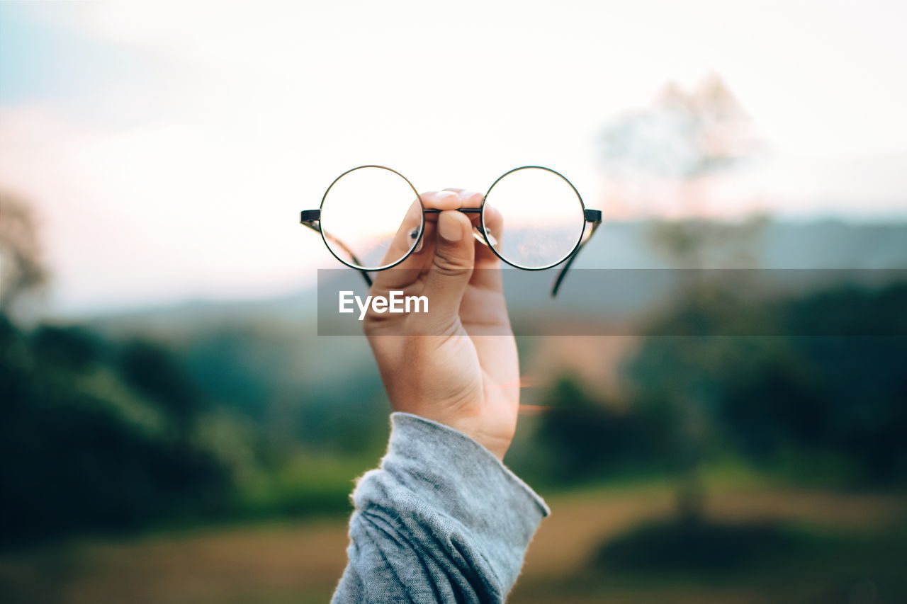 Close-up of hand holding eyeglasses