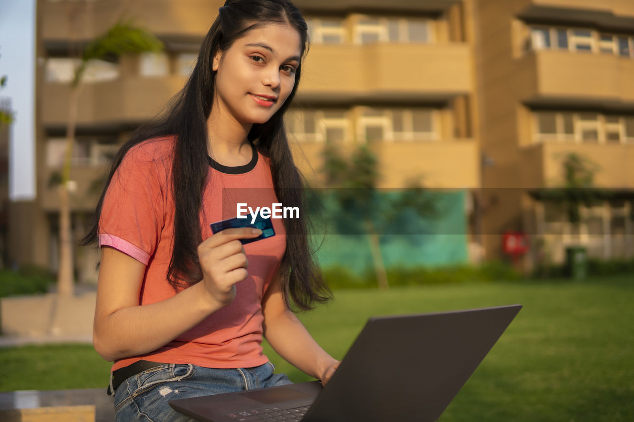 portrait of young woman using phone