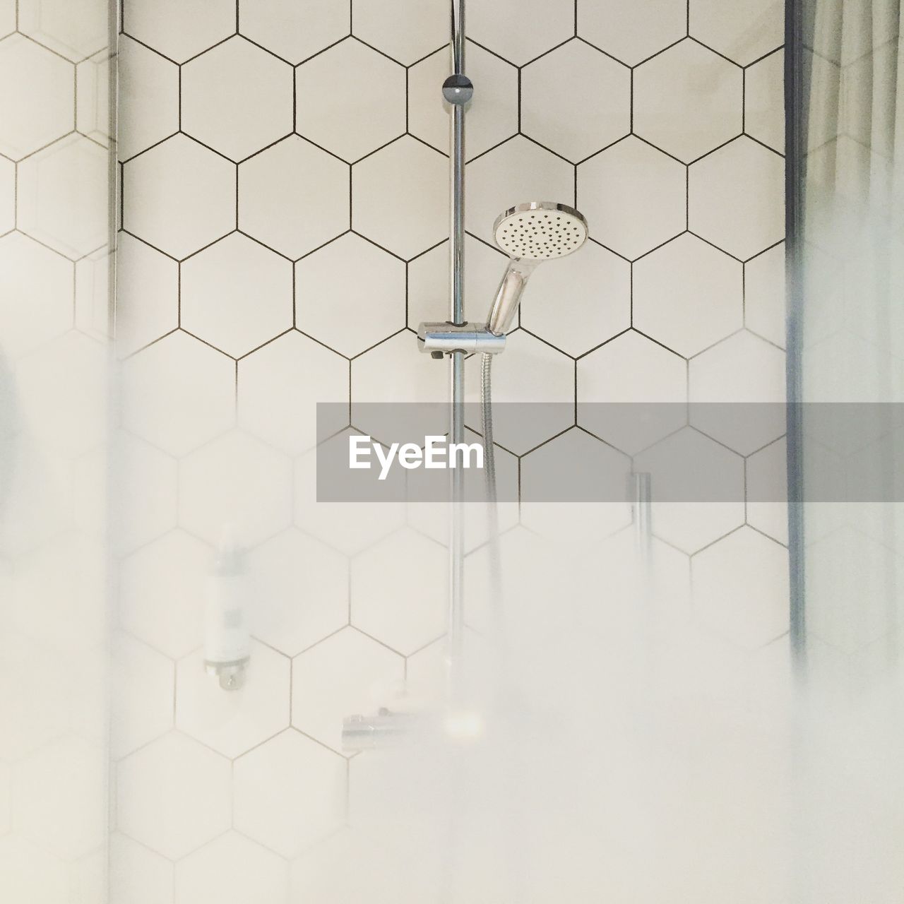 Shower head and with steam in bathroom