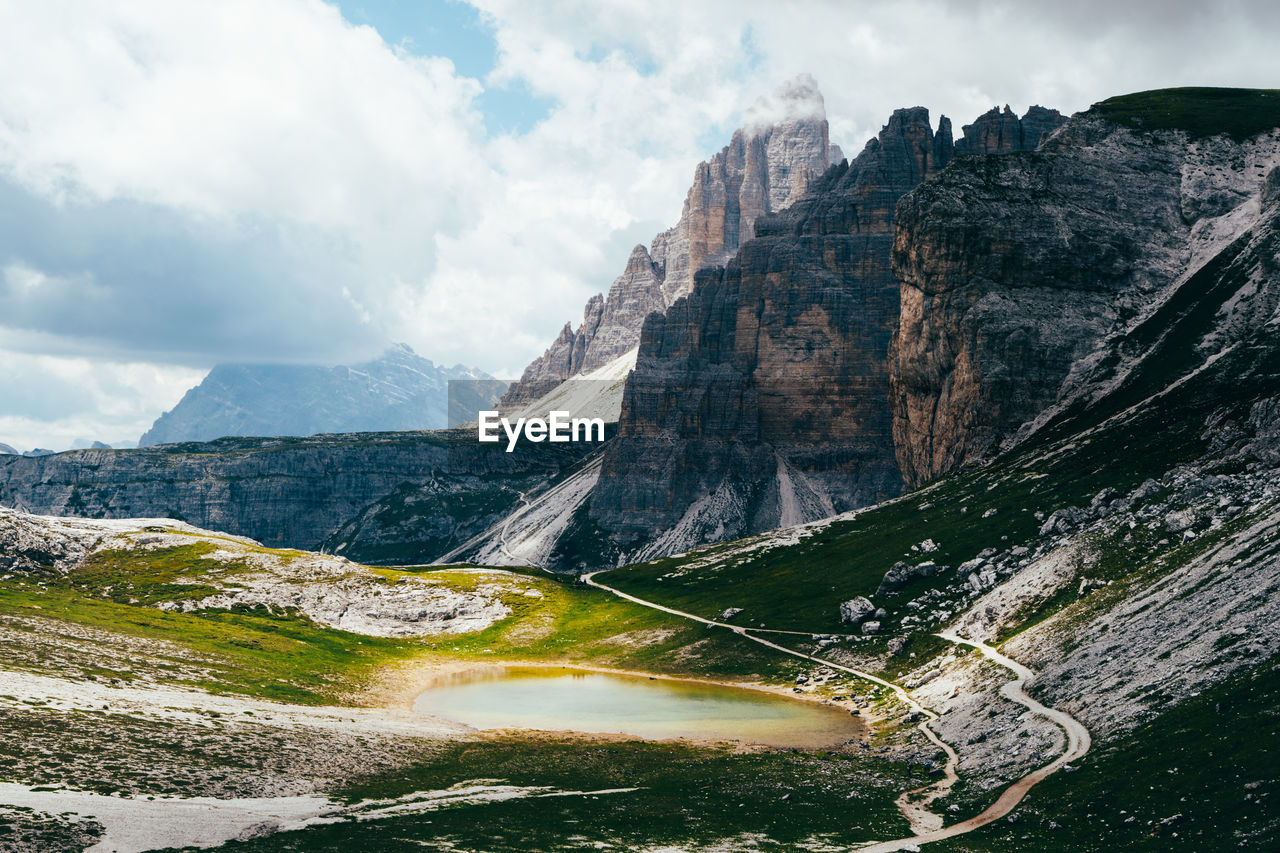 Panoramic view of road by mountains against sky