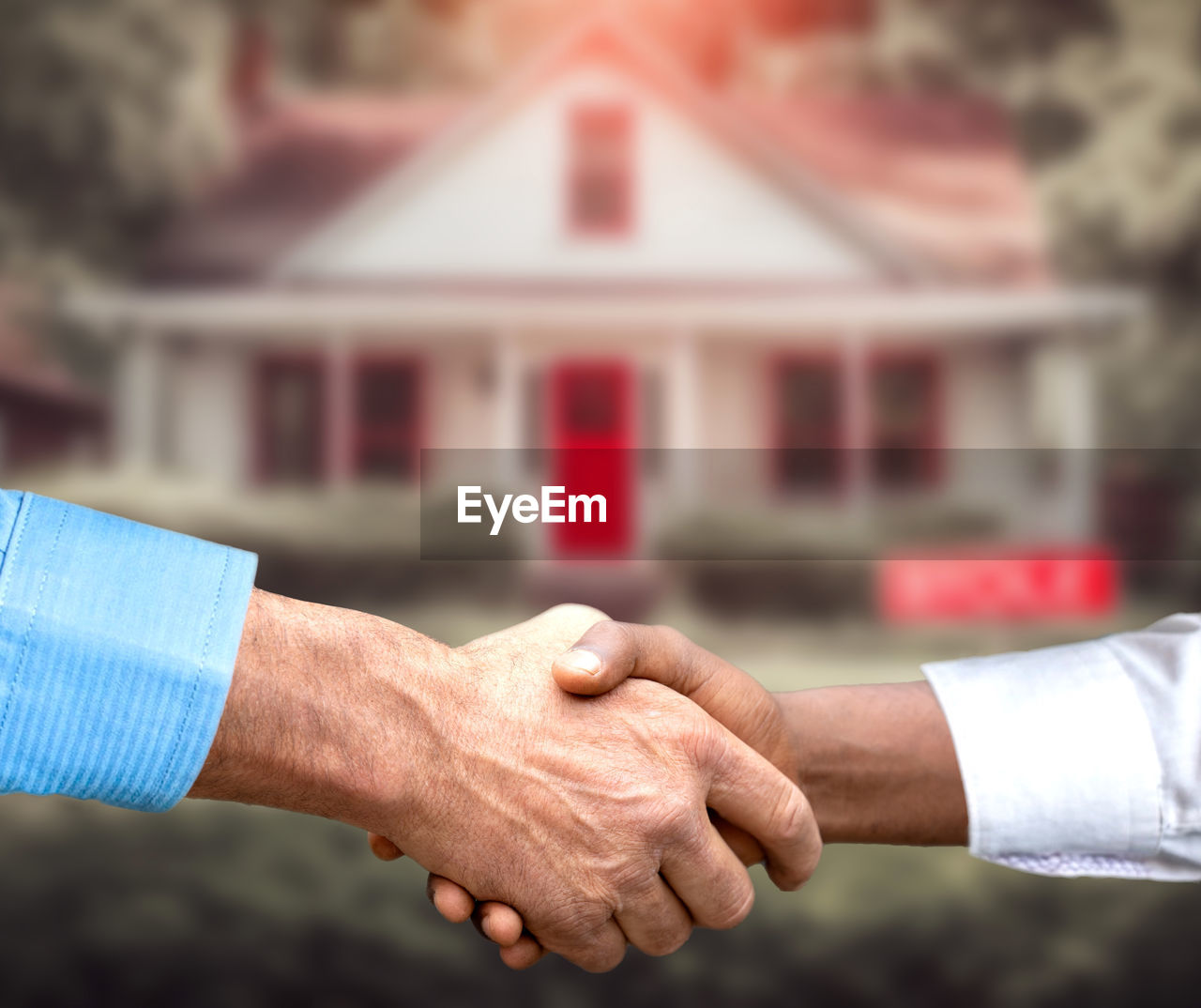 close-up of business colleagues shaking hands in office