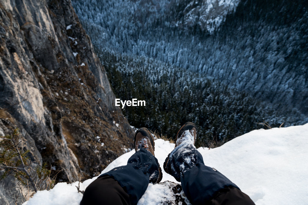 Low section of person on snowcapped mountain