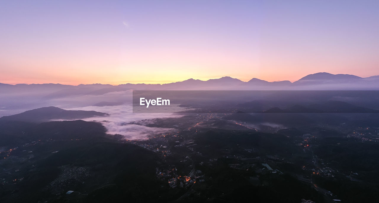 SCENIC VIEW OF MOUNTAINS AGAINST SKY AT SUNSET
