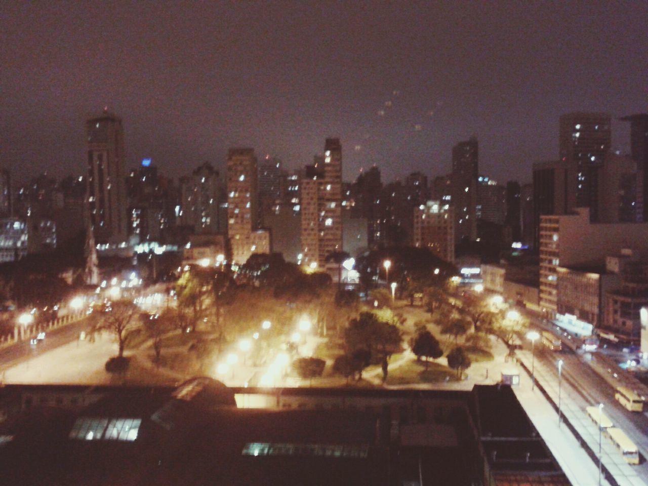 VIEW OF ILLUMINATED CITYSCAPE AT NIGHT