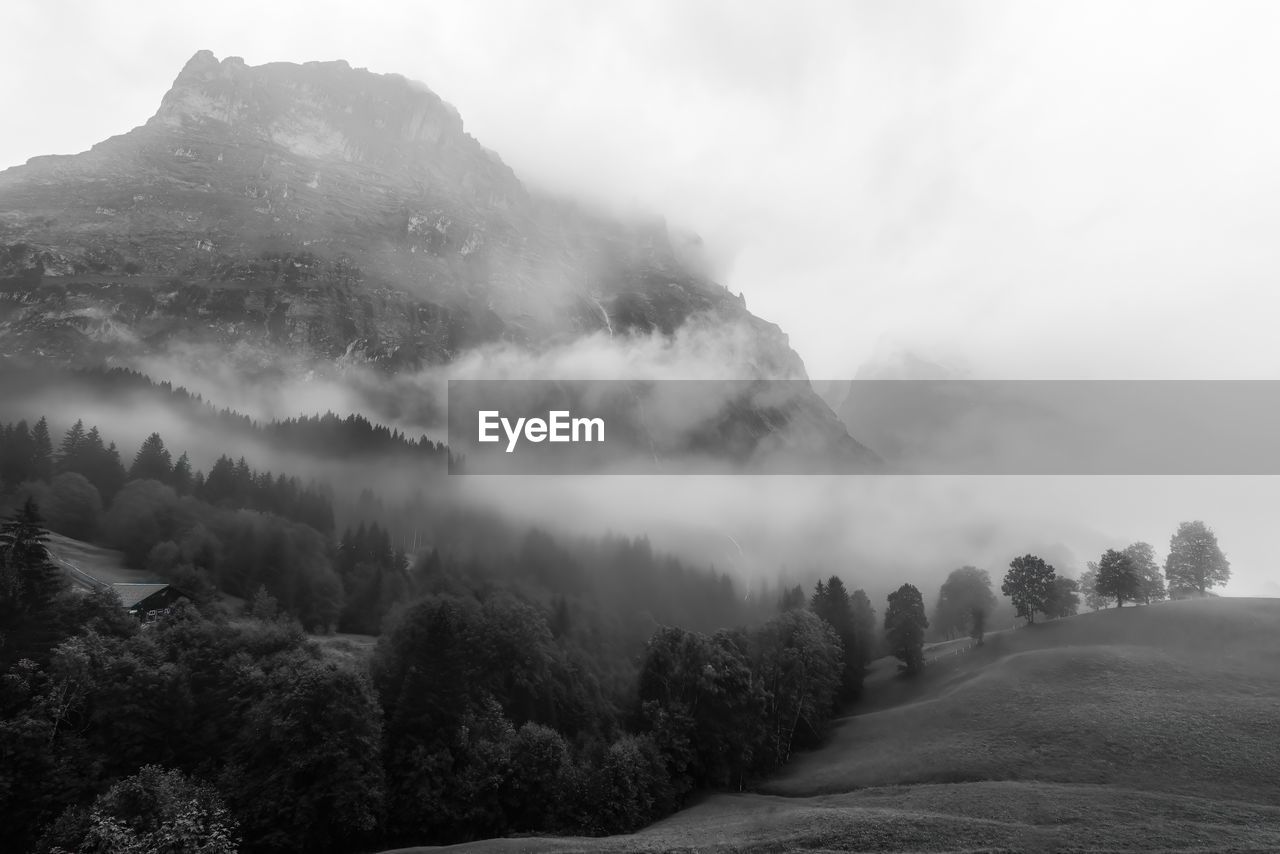 Foggy scenic morning view of mättenberg mountain against the sky  in grindelwald, switzerland