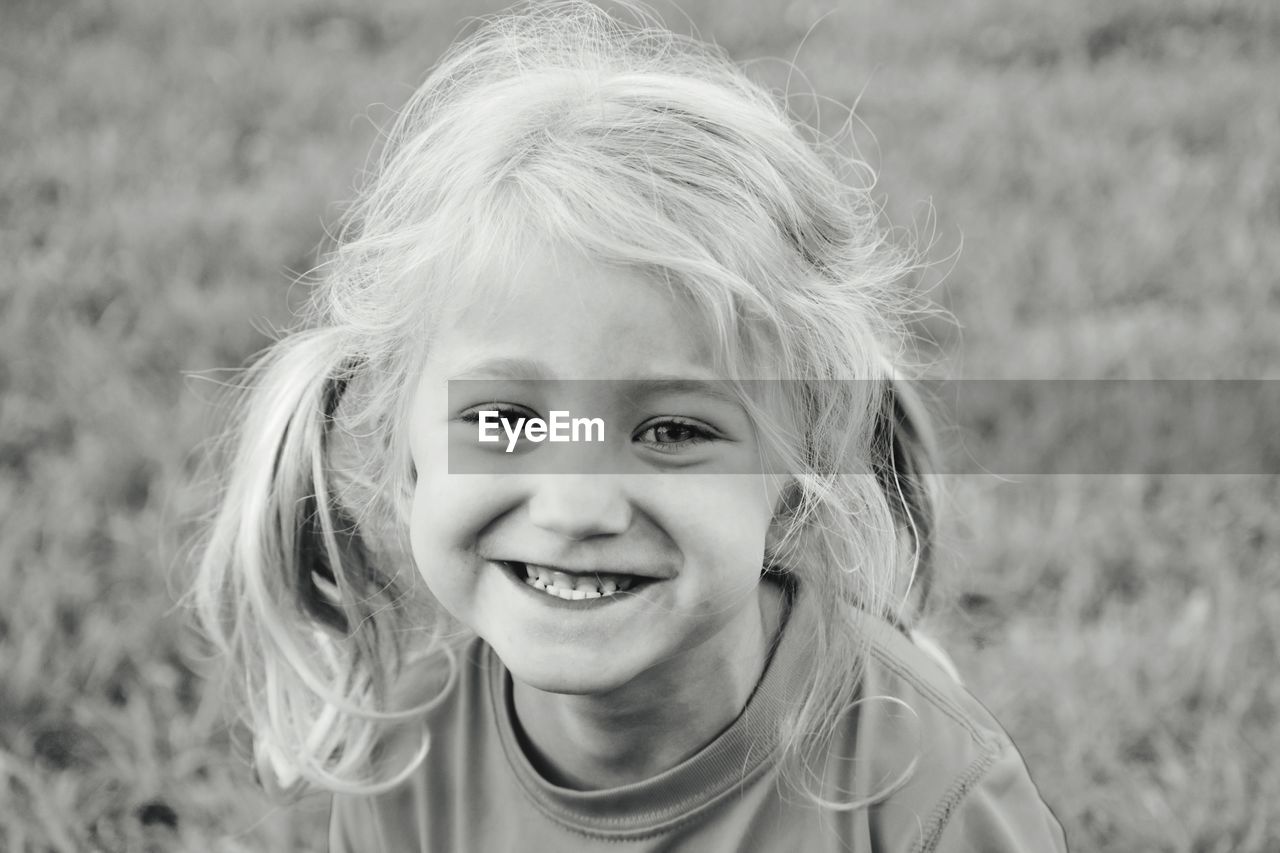 Portrait of smiling girl on field