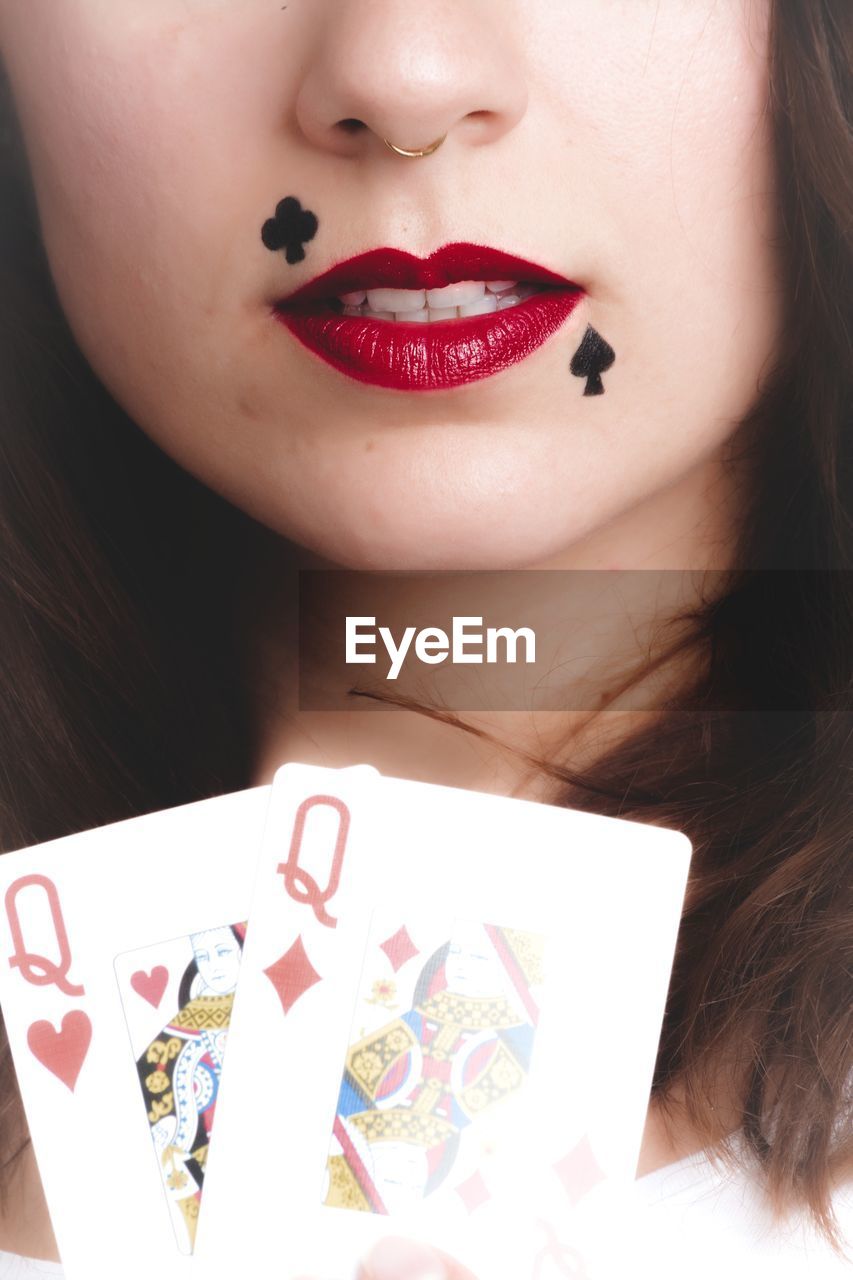 Cropped image of woman with playing cards