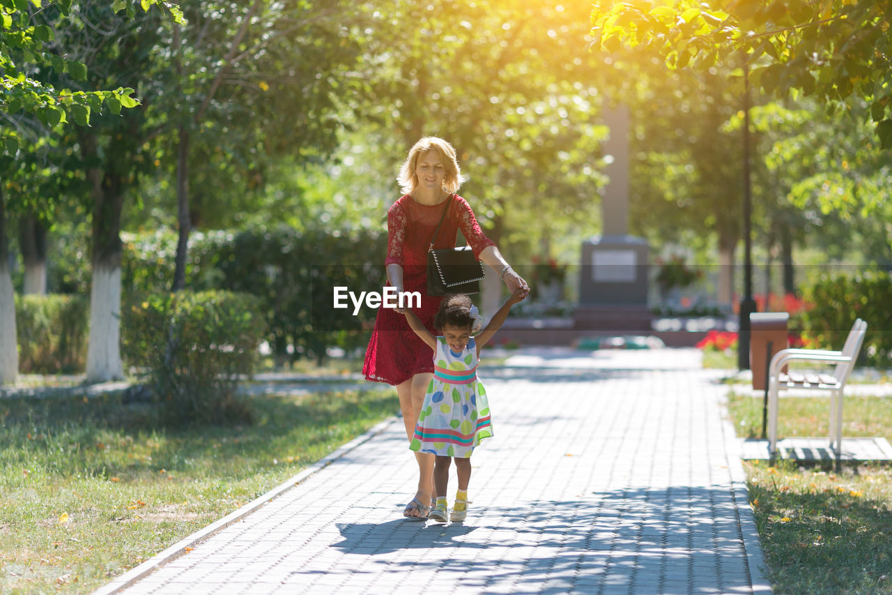 Mother and daughter at park on sunny day