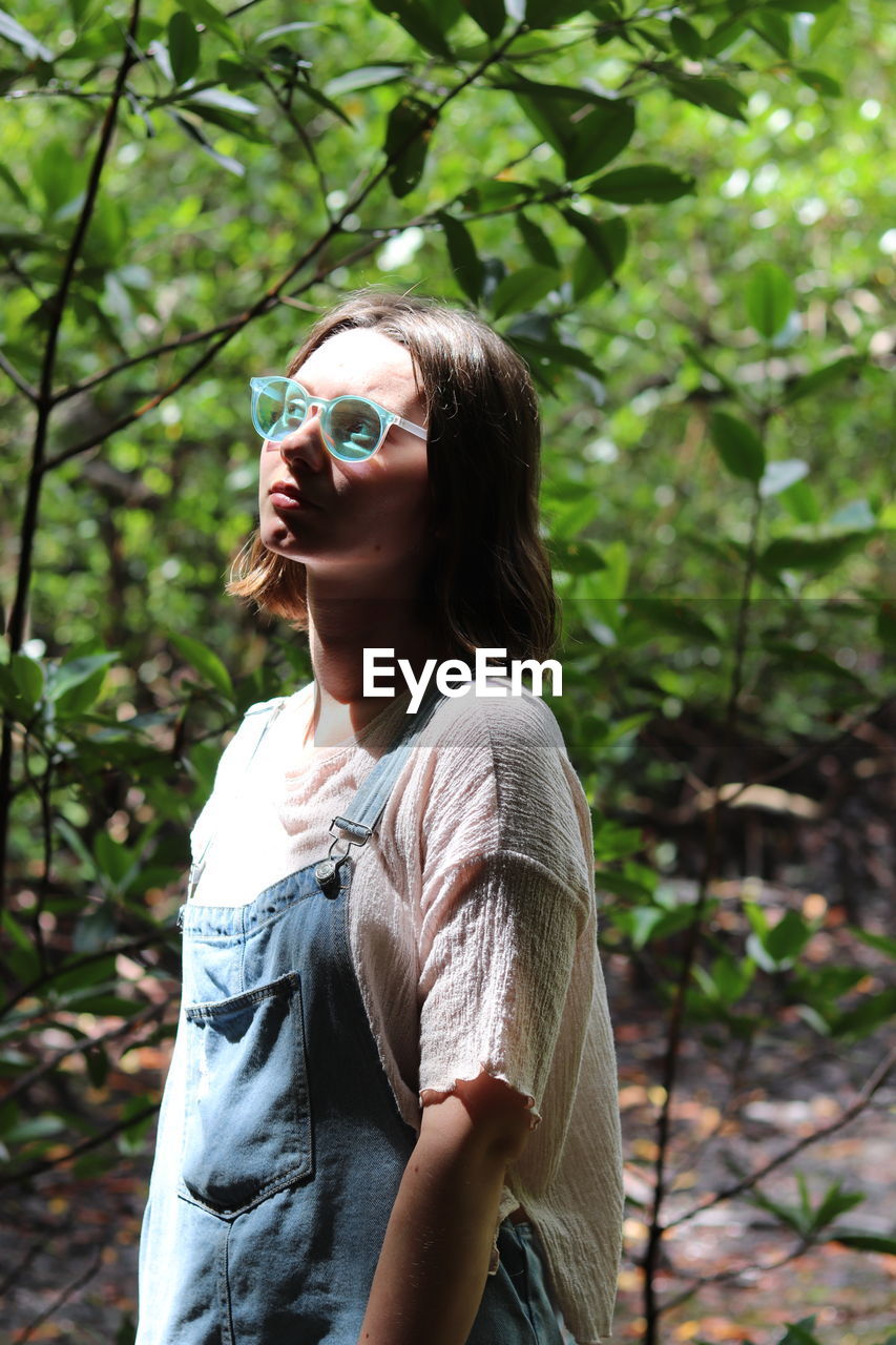 Young woman looking at camera in forest