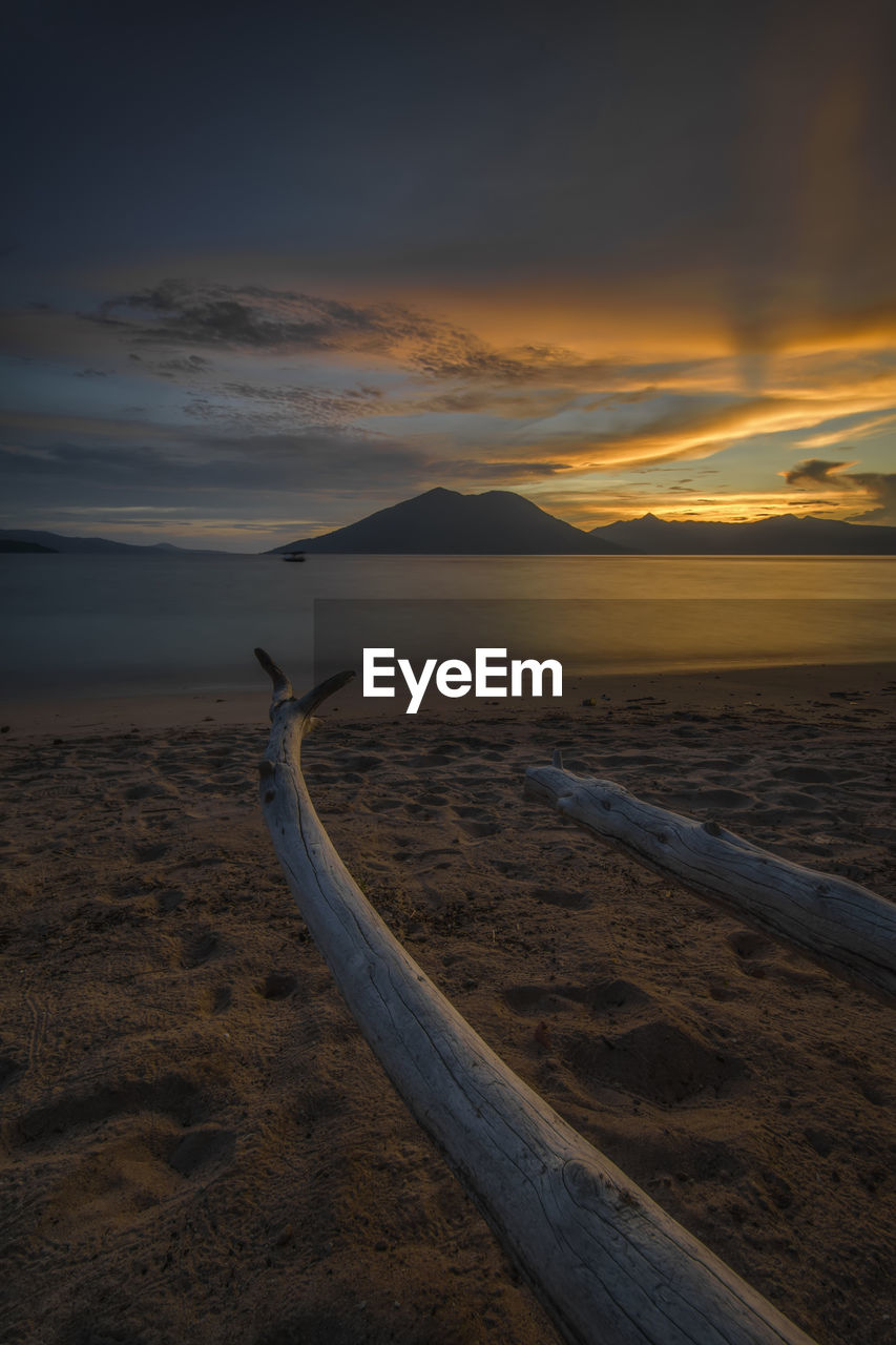 Scenic view of beach against sky during sunset