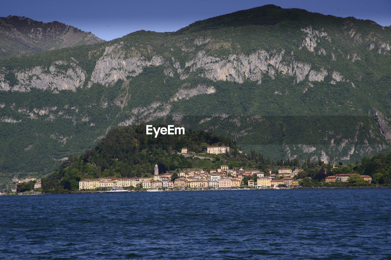 SCENIC VIEW OF SEA AND BUILDINGS AGAINST SKY