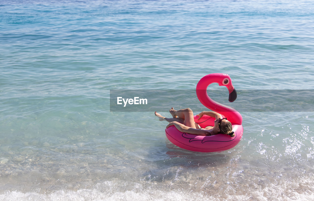 high angle view of woman swimming in sea