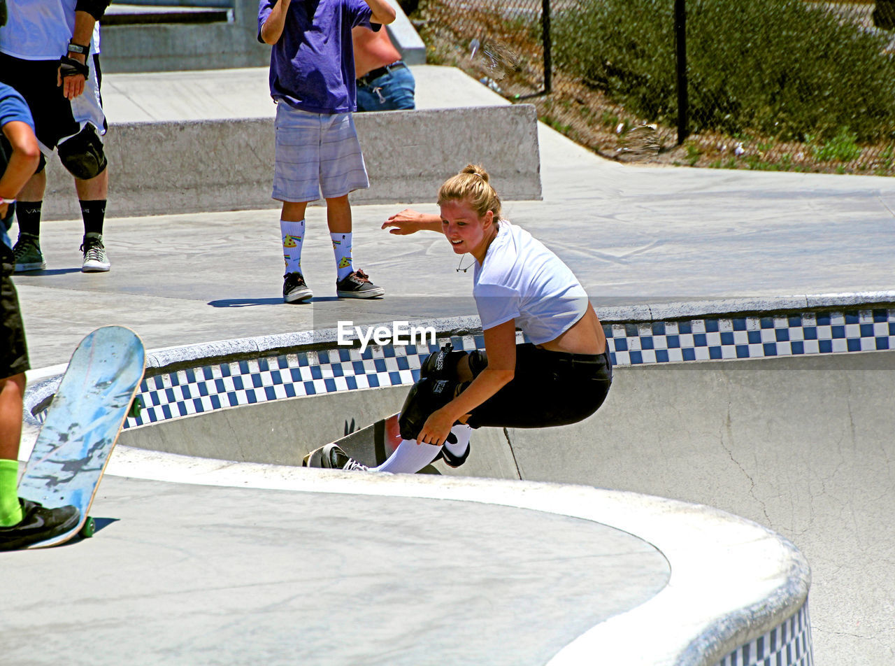 REAR VIEW OF BOY SKATEBOARDING