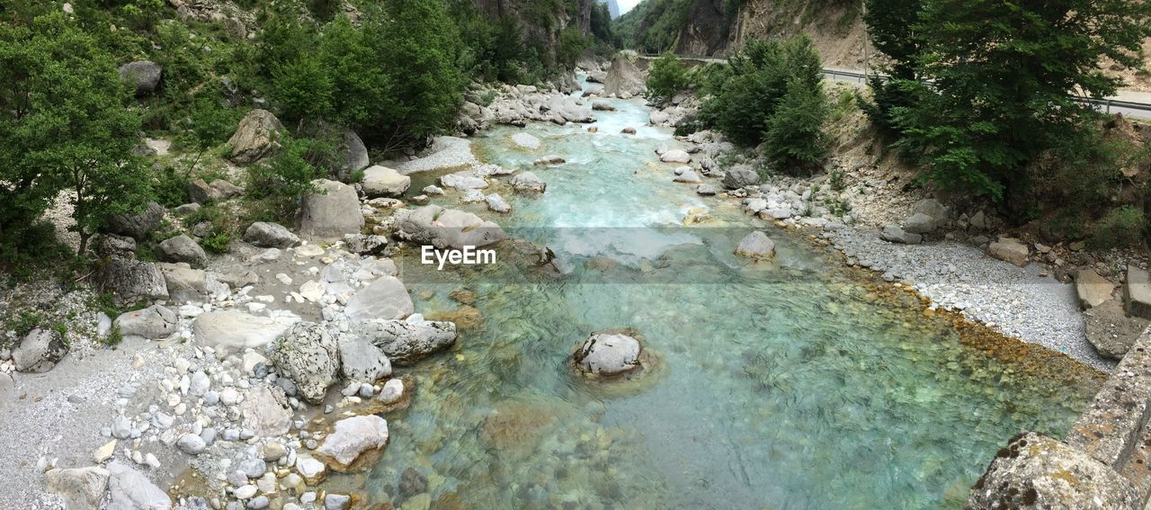 High angle view of stream amidst rocks in forest