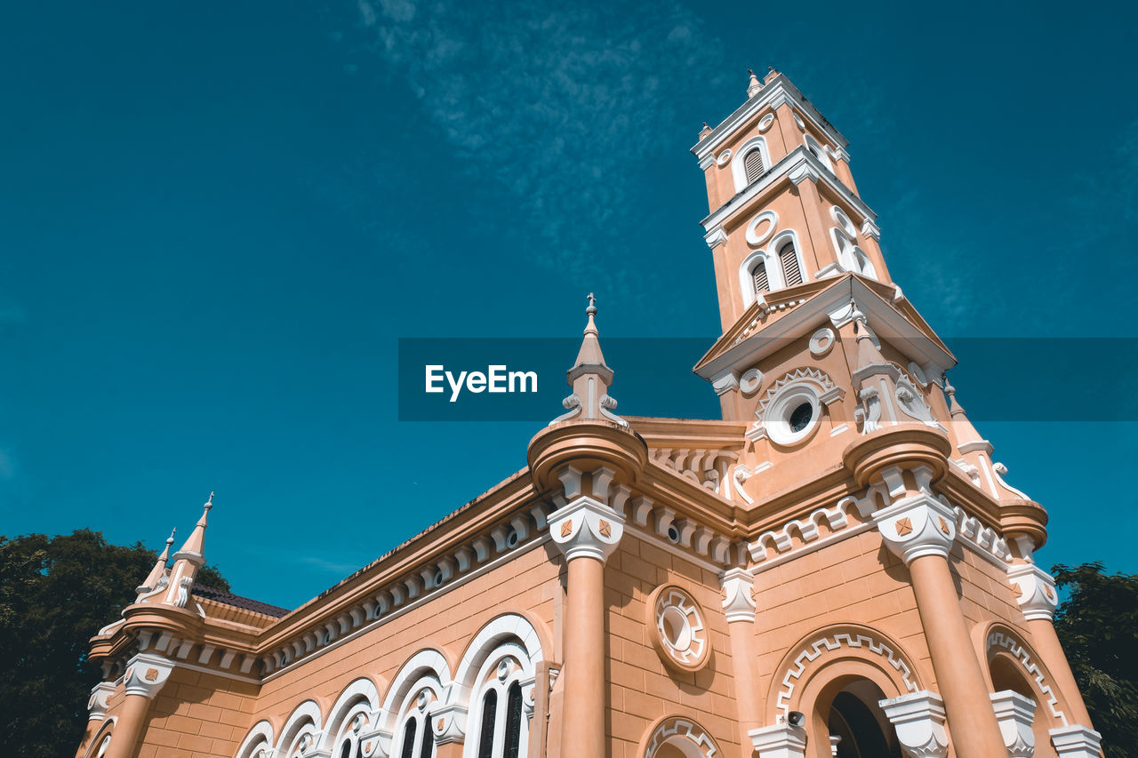 Low angle view of historic building against blue sky