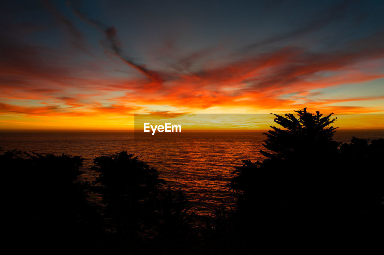Scenic view of sea against romantic sky at sunset
