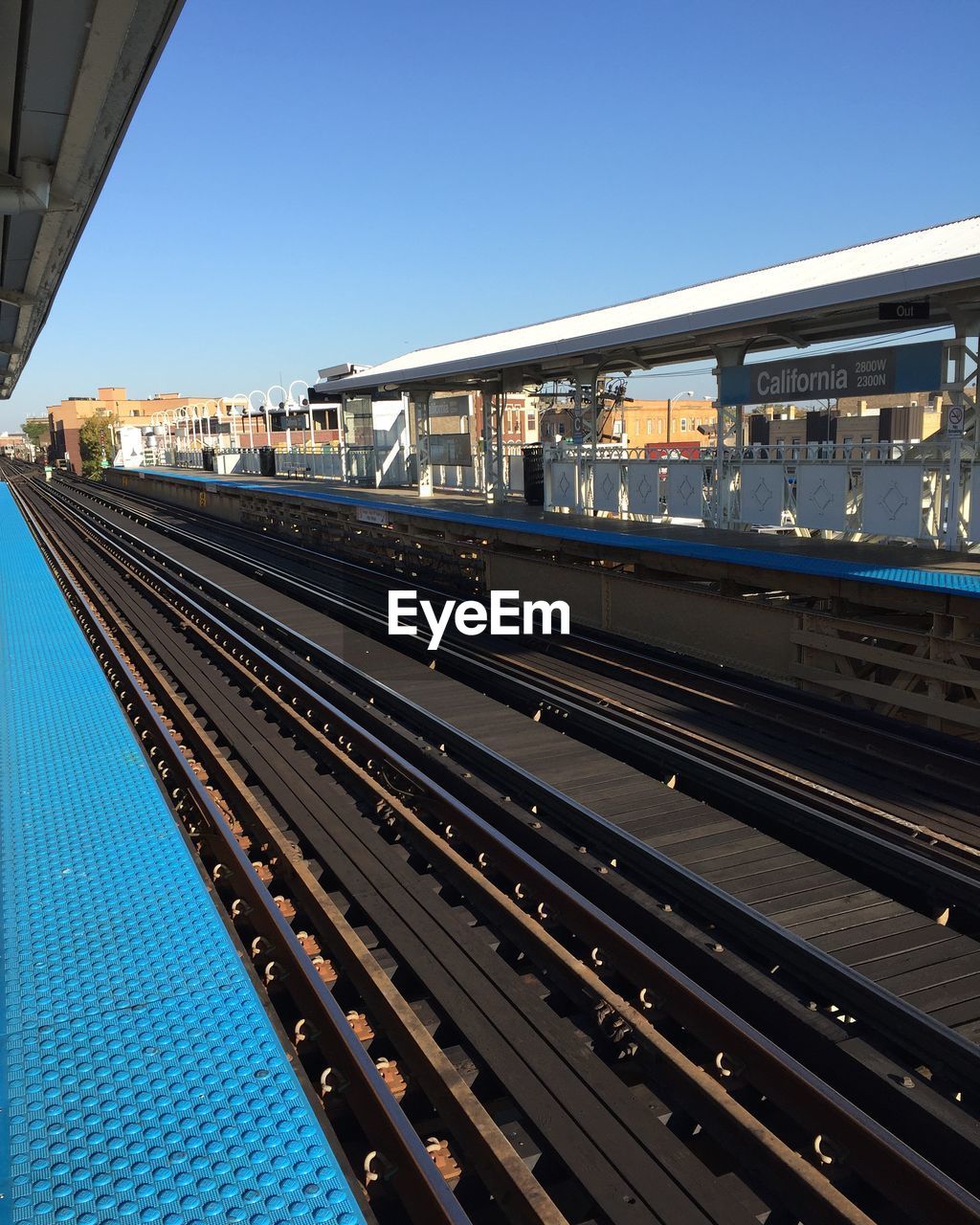 Empty railroad station against clear sky