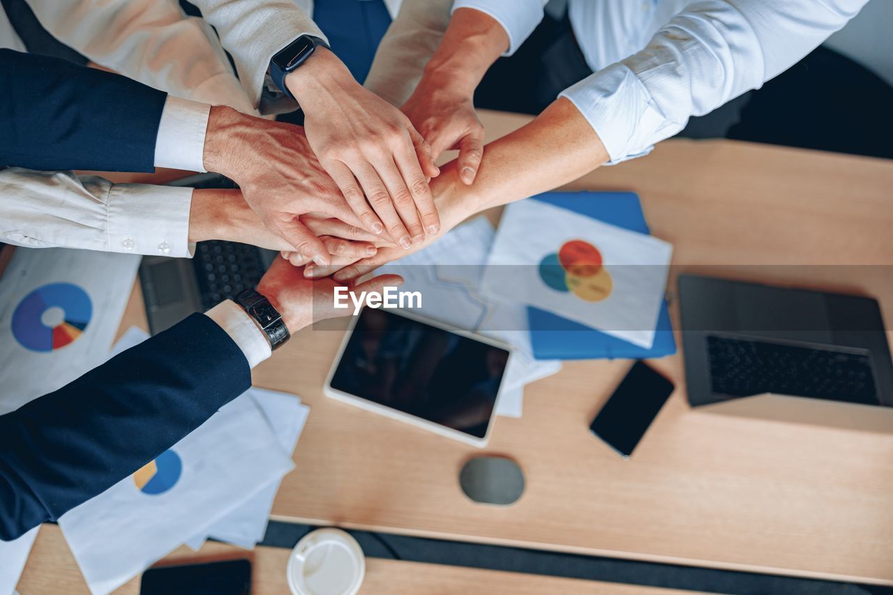 high angle view of business colleagues shaking hands