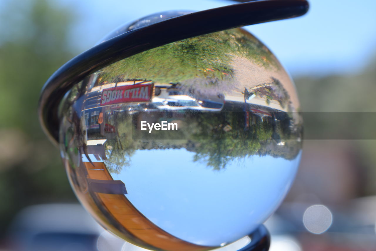 REFLECTION OF UPSIDE DOWN IMAGE OF WATER BALL ON GLASS