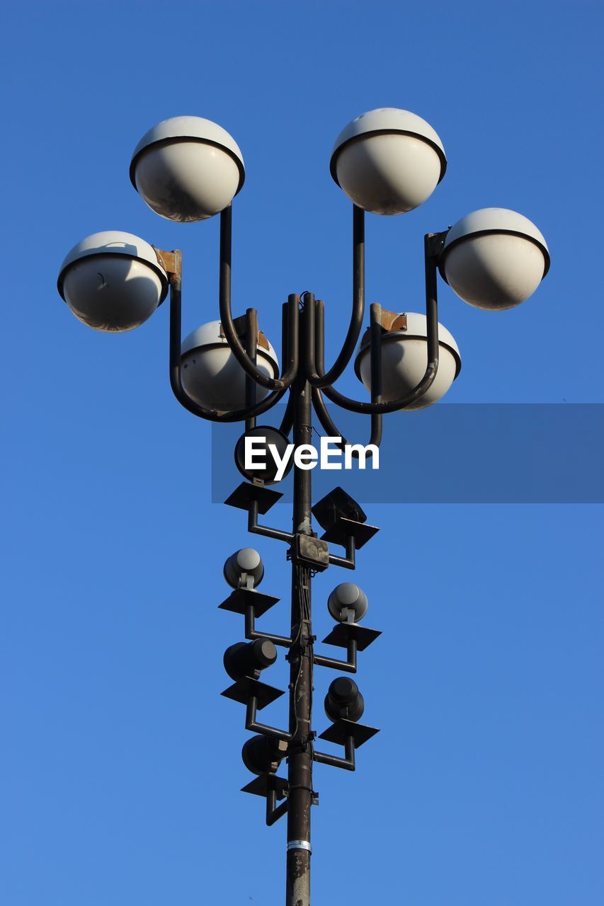 Low angle view of lamp post against clear blue sky