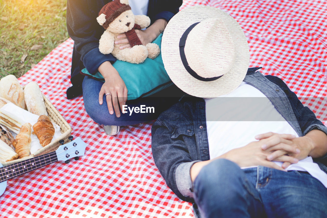 People relaxing on picnic blanket