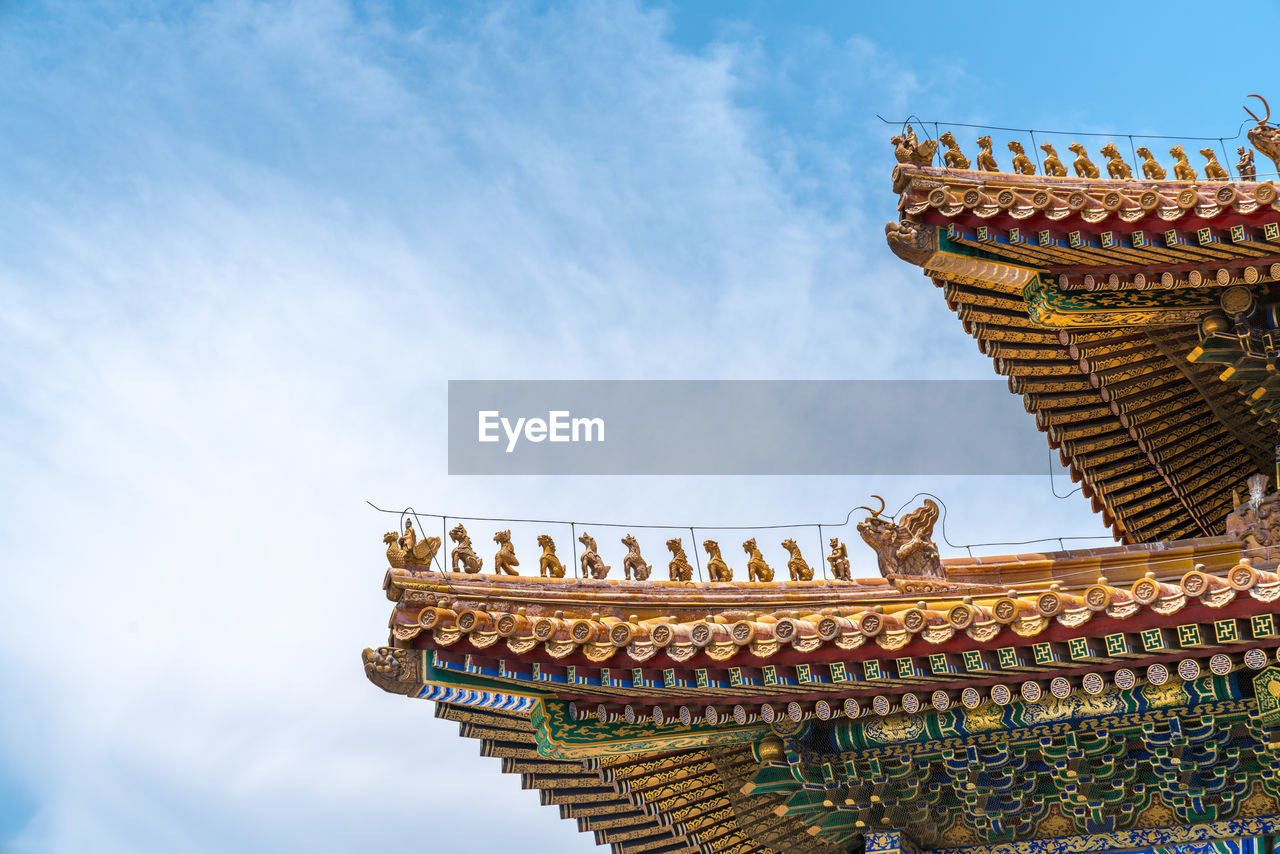 LOW ANGLE VIEW OF TEMPLE AGAINST CLOUDY SKY