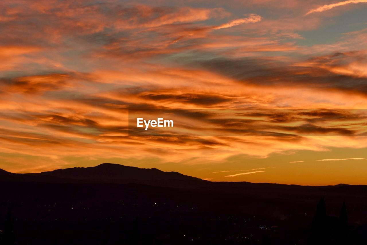 SCENIC VIEW OF DRAMATIC SKY OVER SILHOUETTE LANDSCAPE