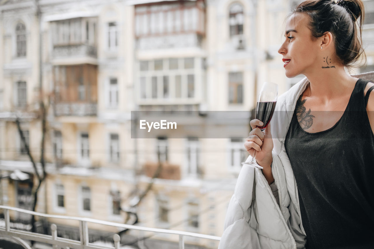 Woman looking at city buildings