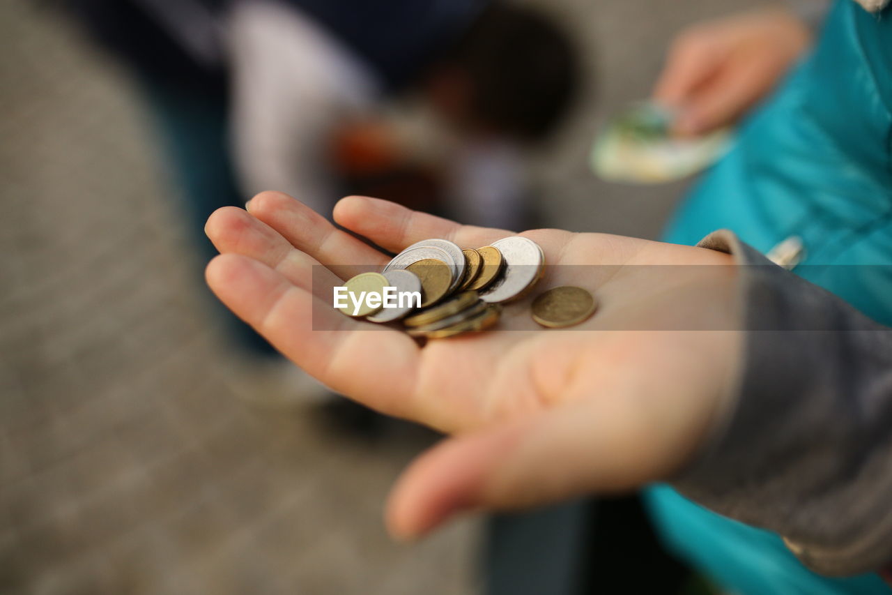 Midsection of child holding coins