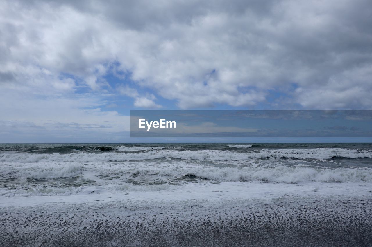 SCENIC VIEW OF BEACH AGAINST SKY DURING SUNSET