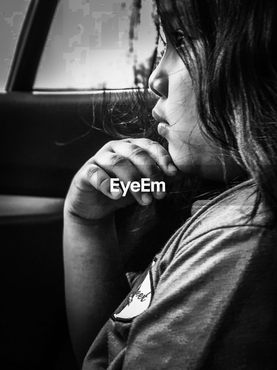 Close-up of girl sitting in car